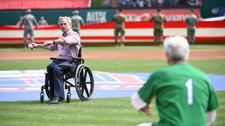 FILE: Texas Governor Greg Abbott throws out the ceremonial first pitch before the game between the Chicago Cubs and the Texas Rangers at Globe Life Park in Arlington on Thursday, March 28, 2019 in Arlington, Texas.