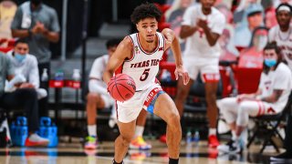 Guard Micah Peavy #5 of the Texas Tech Red Raiders handles the ball during the first half of the college basketball game against the Kansas Jayhawks at United Supermarkets Arena on Dec. 17, 2020 in Lubbock, Texas.