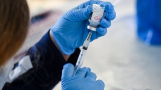 A healthcare worker fills a syringe with Moderna COVID-19 vaccine. At the Giorgio Companies site in Blandon, PA where the CATE Mobile Vaccination Unit was onsite to administer Moderna COVID-19 Vaccines to workers Wednesday morning April 14, 2021.