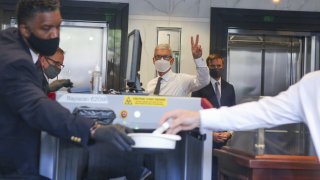 Tim Cook, chief executive officer of Apple Inc., center, arrives at U.S. district court in Oakland, California, on Friday, May 21, 2021.