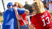 Texas Rangers manager Chris Woodward gives a hug to superfan and "Cookie Lady" Shirley Kost.