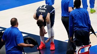 Dallas Mavericks guard Luka Doncic leans over as he heads to the bench during a timeout in fourth quarter of an NBA playoff basketball game against the LA Clippers at American Airlines Center on Friday, May 28, 2021, in Dallas.