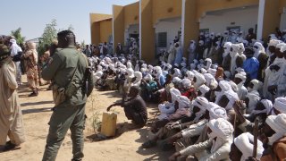 Security forces take measures as people wait to get tested for coronavirus (COVID-19) in Chad's capital and largest city N'Djamena as daily life continues in crowded areas amid the COVID-19 pandemic, on December 27, 2020.