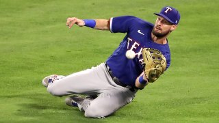 ANAHEIM, CALIFORNIA – MAY 25: David Dahl #21 of the Texas Rangers makes the catch hit by Taylor Ward #3 of the Los Angeles Angels during the fifth inning at Angel Stadium of Anaheim on May 25, 2021 in Anaheim, California.