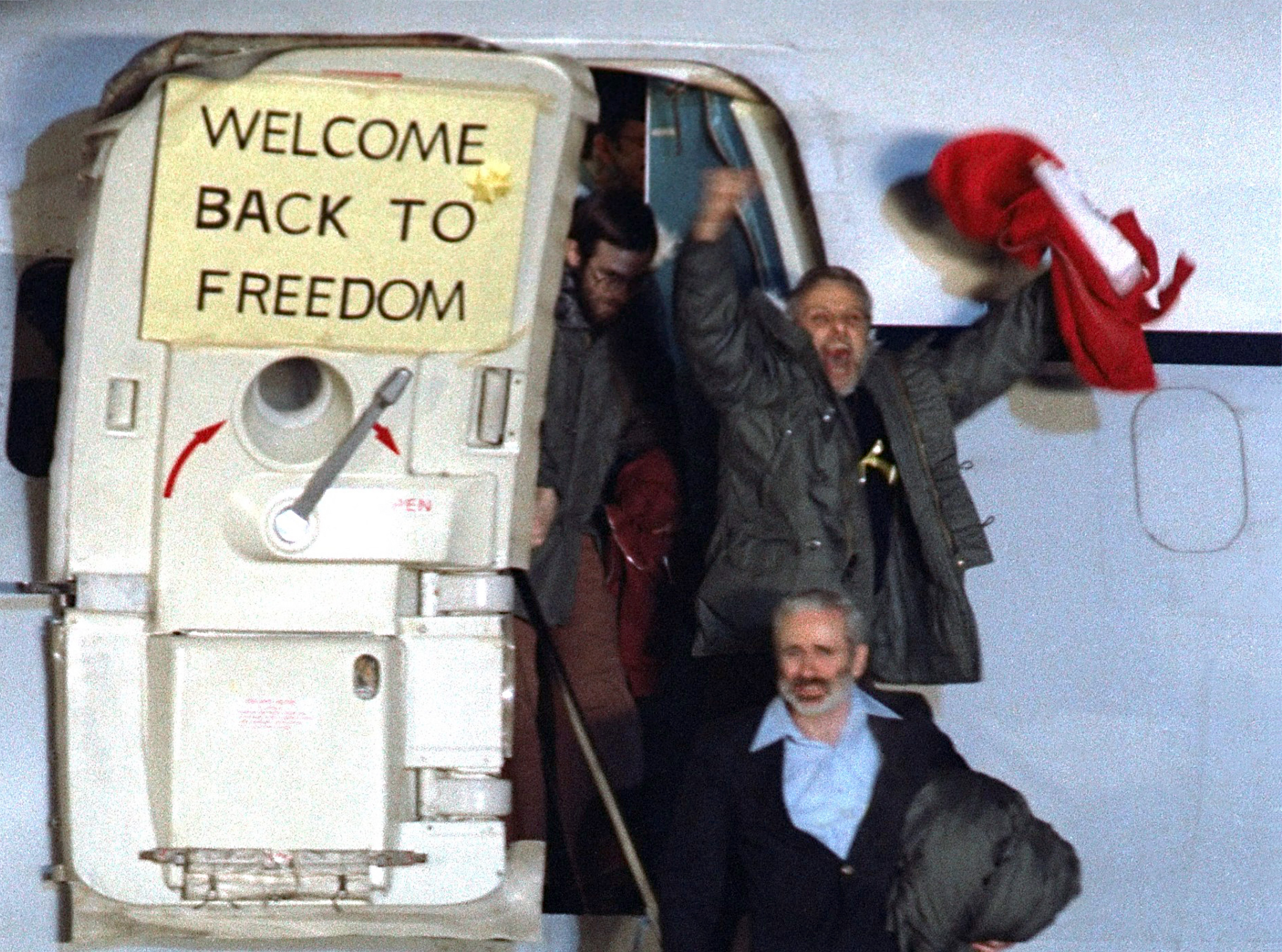 David Roeder shouts and waves as he and others arrive at Rhein-Main U.S. Air Force base in Frankfurt, West Germany from Algeria on Jan. 21, 1981.  He was among 52 Americans held hostage in Iran for 444 days after their capture at the U.S. Embassy in Tehran. The crisis was one of the defining moments of Carter’s presidency that led to the loss of his reelection bid for the White House.