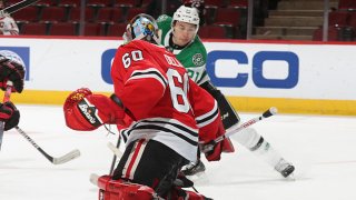 Jason Robertson #21 of the Dallas Stars scores a goal past Collin Delia #60 of the Chicago Blackhawks during the overtime period at United Center on May 10, 2021 in Chicago, Illinois. The Stars defeated the Blackhawks 5-4.