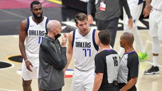 Head coach Rick Carlisle and Luka Doncic #77 of the Dallas Mavericks argue with referees David Guthrie #16 and Michael Smith #38 during the third quarter of the game between the Dallas Mavericks and the Cleveland Cavaliers at Rocket Mortgage Fieldhouse on May 9, 2021 in Cleveland, Ohio.