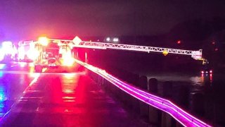 Ennis Fire Department crews rescue three people from a vehicle stuck in high water in Palmer, Texas on Saturday, May 22, 2021.