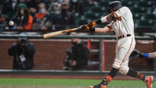 San Francisco Giants shortstop Mauricio Dubon (1) hits a RBI single during the seventh inning against the Texas Rangers at Oracle Park.