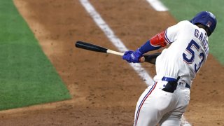 Adolis Garcia #53 of the Texas Rangers hits a solo home run against the Houston Astros during the seventh inning at Globe Life Field on May 22, 2021 in Arlington, Texas.