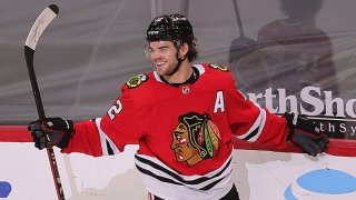 Alex DeBrincat #12 of the Chicago Blackhawks celebrates his 31st goal of the season in the third period against the Dallas Stars at the United Center on May 9, 2021 in Chicago, Illinois. The Blackhawks defeated the Stars 4-2.