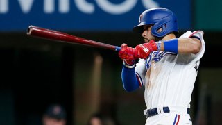 Isiah Kiner-Falefa #9 of the Texas Rangers hits an RBI triple during the sixth inning of a game against the Boston Red Sox at Globe Life Field May 1, 2021 in Arlington, Texas.