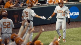 Texas’ Eric Kennedy, right, celebrates scoring a run against Fairfield in the second inning of an NCAA college baseball regional tournament at Disch-Falk Field, Sunday on June 6, 2021, in Austin, Texas. (Austin American-Statesman via AP)