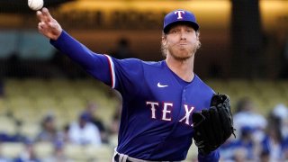 Texas Rangers starting pitcher Mike Foltynewicz throws to first as he tries to get Los Angeles Dodgers’ Mookie Betts off base during the first inning of a baseball game Friday, June 11, 2021, in Los Angeles. (AP Photo/Mark J. Terrill)