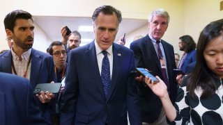 Sen. Mitt Romney, R-Utah, is surrounded by reporters as he walks to the Senate chamber for votes, at the Capitol in Washington, Thursday, June 10, 2021. Sen. Romney is working with a bipartisan group of 10 senators negotiating an infrastructure deal with President Joe Biden.
