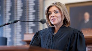 FILE: Texas Supreme Court justice, Eva Guzman of Houston, is sworn into office by Texas Governor Rick Perry in ceremonies at the Texas Capitol. Guzman is a well-respected family law judge who grew up in an impoverished Houston home. Texas Supreme Court justice, Eva Guzman of Houston, is sworn into office by Texas Governor Rick Perry in ceremonies at the Texas Capitol. Guzman is a well-respected family law judge who grew up in an impoverished Houston home.