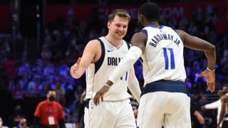 Luka Doncic #77 of the Dallas Mavericks high fives Tim Hardaway Jr. #11 of the Dallas Mavericks during Round 1, Game 5 of the 2021 NBA Playoffs on June 2, 2021 at STAPLES Center in Los Angeles, California.