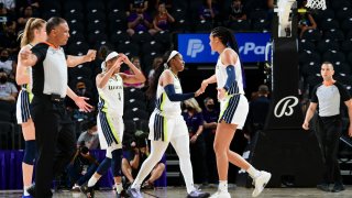 Arike Ogunbowale #24 of the Dallas Wings high fives Satou Sabally #0 of the Dallas Wings during the game against the Phoenix Mercury on June 11, 2021 at Phoenix Suns Arena in Phoenix, Arizona.