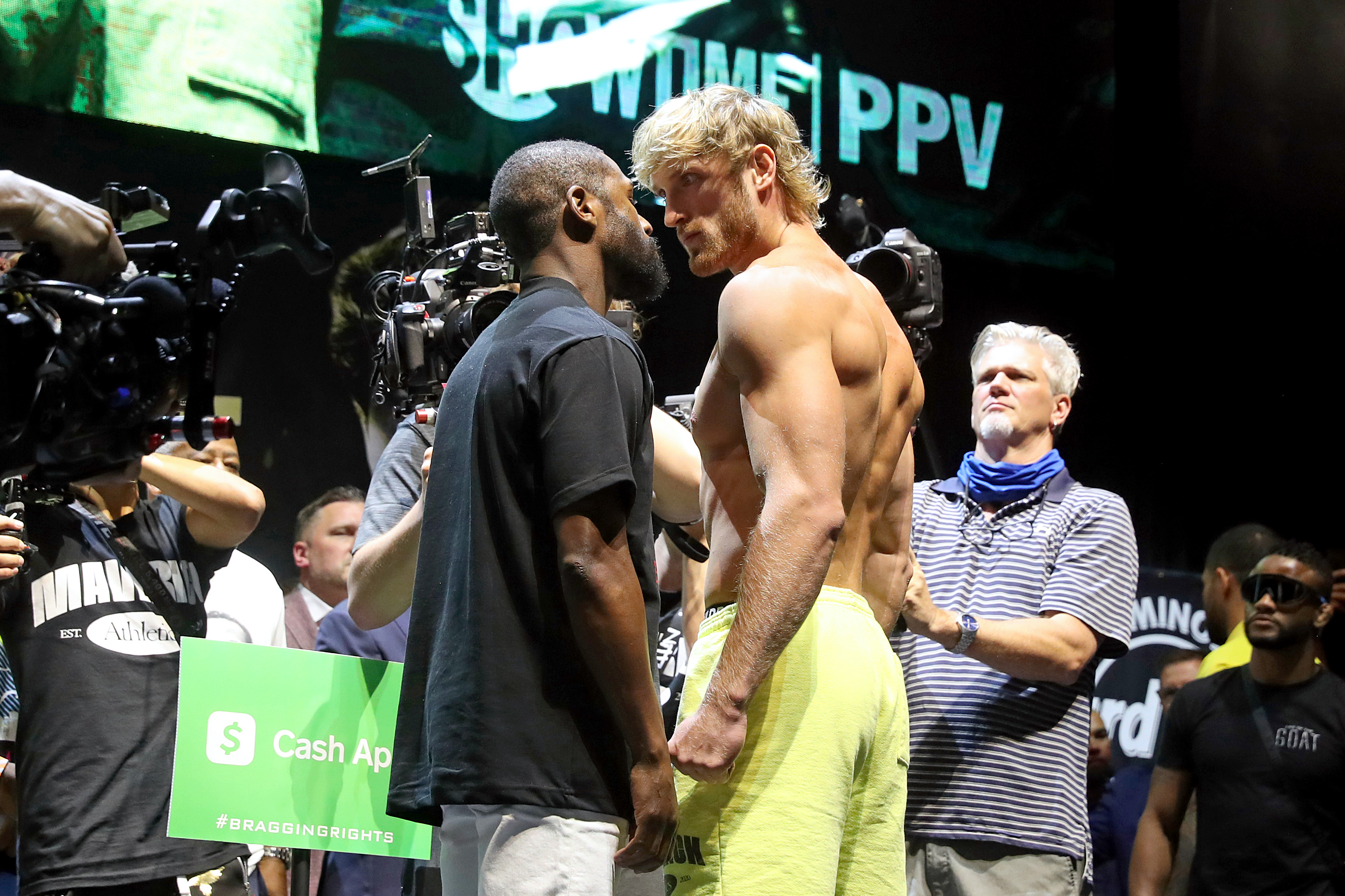 MIAMI GARDENS, FLORIDA – JUNE 05: Floyd Mayweather and Logan Paul face off during the weigh-in ahead of the June 6th exhibition boxing match between Floyd Mayweather and Logan Paul on June 5, 2021 at Hard Rock Live at Seminole Hard Rock Casino in Miami Gardens, Florida. (Photo by Johnny Nunez/Getty Images)