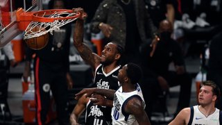 Kawhi Leonard #2 of the Los Angeles Clippers dunks the ball against Dorian Finney-Smith #10 of the Dallas Mavericks during the first half of Game Seven of the Western Conference first round series at Staples Center on June 6, 2021 in Los Angeles, California.