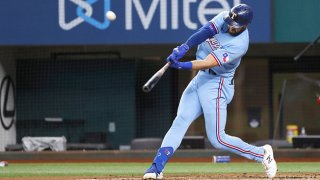 Joey Gallo hitting a baseball with a baseball bat.