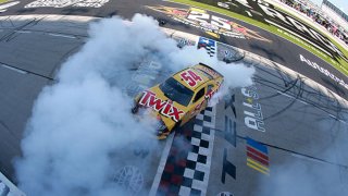 Kyle Busch, driver of the #54 Twix Toyota, celebrates with a burnout after winning the NASCAR Xfinity Series Alsco Uniforms 250 at Texas Motor Speedway on June 12, 2021 in Fort Worth, Texas.