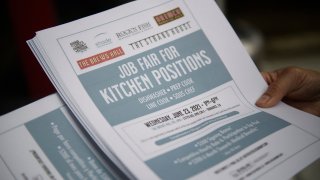 An employer holds flyers for hospitality employment during a Zislis Group job fair at The Brew Hall on June 23, 2021 in Torrance, California.