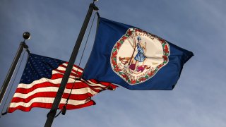 File photo. The Virginia State flag and the American flag fly near the Virginia State Capitol.