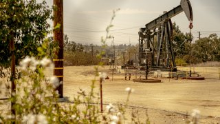 An oil pump jack operates at the Inglewood Oil Field in Culver City, California, U.S., on Sunday, July 11, 2021.