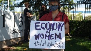 An employee holds a sign during a walkout at Activision Blizzard offices in Irvine, California, U.S., on Wednesday, July 28, 2021.