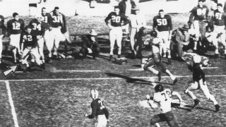 File-This Jan. 1, 1954, file photo shows Alabama fullback Tommy Lewis (42) (arrow) coming off the bench getting ready to tackle Rice halfback Dicky Moegle (47), as he crosses the 50 yard line during the Cotton Bowl at Arlington, Tex., Jan. 1, 1954. Maegle, the Rice running back tackled in the 1954 Cotton Bowl by an Alabama player who came off the bench in one of the most legendary plays in college football history, has died. Rice and the National Football Foundation both said Tuesday, July 6, 2021, that Maegle passed away Sunday. He was 86. (Tom Dillard/The Dallas Morning News via AP)