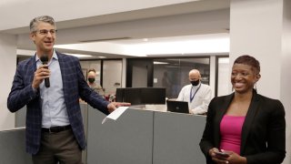 Grant Moise, left, The Dallas Morning News publisher, introduces Katrice Hardy as The News' executive editor, to the newsroom on Wednesday, July 21, 2021, in Dallas, Texas. Hardy, who also will be the first woman to hold the top job at the Dallas newsroom, will take up her duties next month.