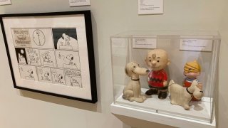A new exhibit on dogs in cartoons and comic strips includes vinyl toys of Charlie Brown and Snoopy and Dennis the Menace and Ruff, from the private collection of exhibit curator Brian Walker