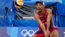 Nicholas Lucena, of the United States, returns a shot during a men's beach volleyball match against Brazil at the 2020 Summer Olympics, Tuesday, July 27, 2021, in Tokyo, Japan.