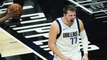 Dallas Mavericks guard Luka Doncic (77) reacts after picking up a basket and a foul against LA Clippers guard Terance Mann (14) during the second quarter of Game 7 of an NBA playoff series at the Staples Center on Sunday, June 6, 2021, in Los Angeles.