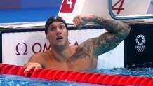 Caeleb Dressel flexes his Florida-themed left arm tattoo, which features animals native to his home state.