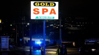 FILE - Officials in front of Gold Spa after a deadly shooting on March 16, 2021, in Atlanta.