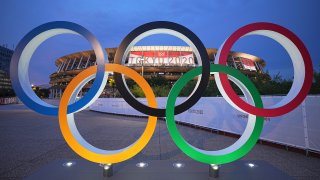 20 July 2021, Japan: In the evening twilight Olympic rings stand in front of the Olympic Stadium. Photo: Michael Kappeler/dpa (Photo by Michael Kappeler/picture alliance via Getty Images)