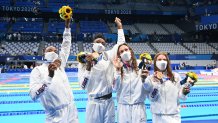 Bronze medallists (from R) USA's Erika Brown, USA's Abbey Weitzeil, USA's Natalie Hinds and USA's Simone Manuel pose after the final of the women's 4x100m freestyle relay swimming event during the Tokyo 2020 Olympic Games at the Tokyo Aquatics Centre in Tokyo on July 25, 2021.