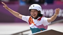 Japan's Momiji Nishiya celebrates after performing a trick during the skateboarding women's street final of the Tokyo 2020 Olympic Games at Ariake Sports Park in Tokyo on July 26, 2021.