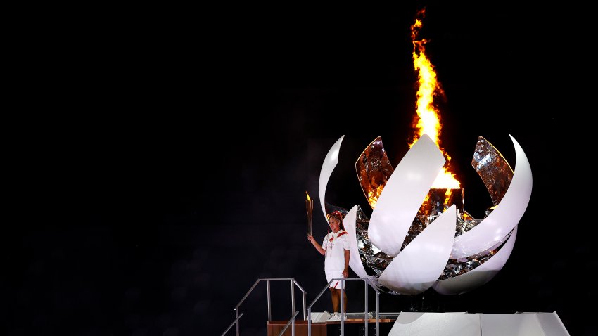 Naomi Osaka of Team Japan carries the Olympic torch to the Olympic cauldron during the Opening Ceremony of the Tokyo 2020 Olympic Games at Olympic Stadium on July 23, 2021 in Tokyo, Japan.