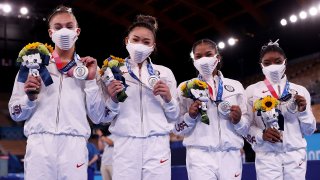 women's gymnastics team shows off silver medals