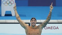 Caeleb Dressel of Team United States reacts after winning the gold medal