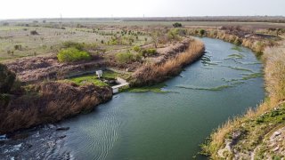 In this aerial photo the river Rio Grande is pictured dividing the cities of Brownsville, Texas (L), and Matamoros, Tamaulipas, Mexico (R) on March 16, 2021.