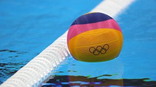 A water polo ball rests atop the water.