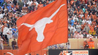 A Texas Longhorns spirit member runs with a flag during game against the Texas Tech Red Raiders on November 29, 2019 at Darrell K Royal-Texas Memorial Stadium in Austin, Texas.