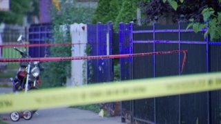 Yellow and red strands of crime scene tape are seen near the area where a toddler was shot in Chicago's Humboldt Park neighborhood