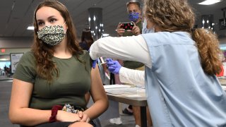 A nurse gives Sherri Trimble, 15, a shot of the vaccine at a vaccination clinic at Health First Medical Centre in Melbourne, Florida.