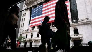 People walk by the New York Stock Exchange (NYSE) on August 10, 2021 in New York City.