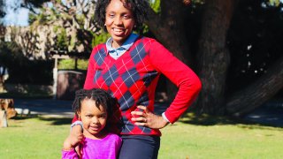 Eraina Ferguson, mom of four, poses with one of her daughters.